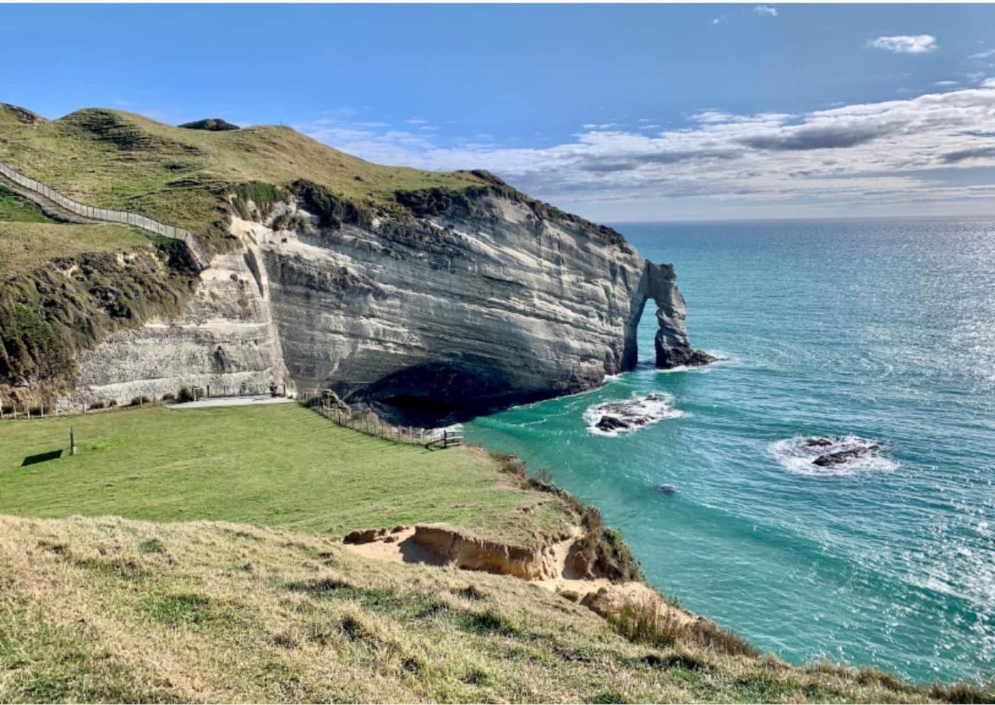 Cape Farewell cliffs and arch above a turquoise sea