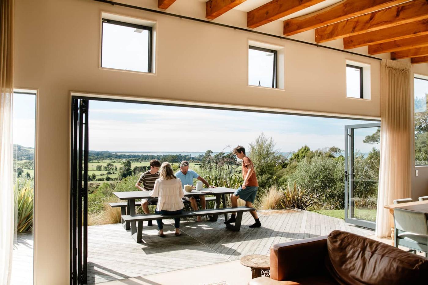 Guests at the outdoor table looking towards the Spit