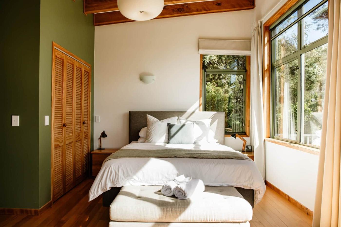 The Tree Top Suite bedroom surrounded by native bush