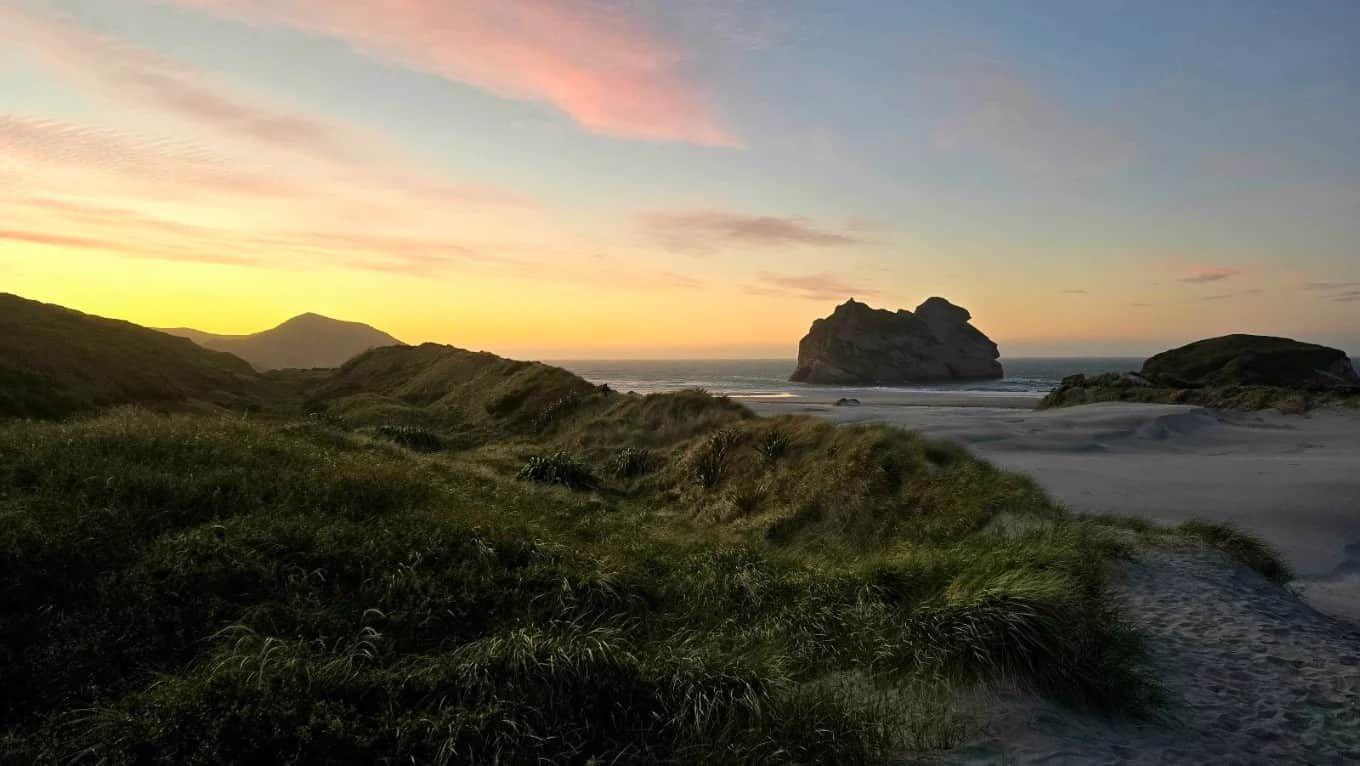 Wharariki Beach at dusk with the Archway Islands